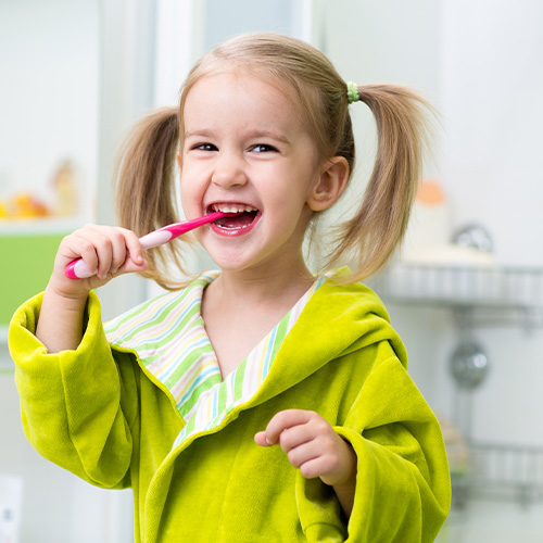 young girl brushing teeth