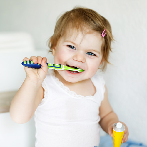 baby with toothbrush