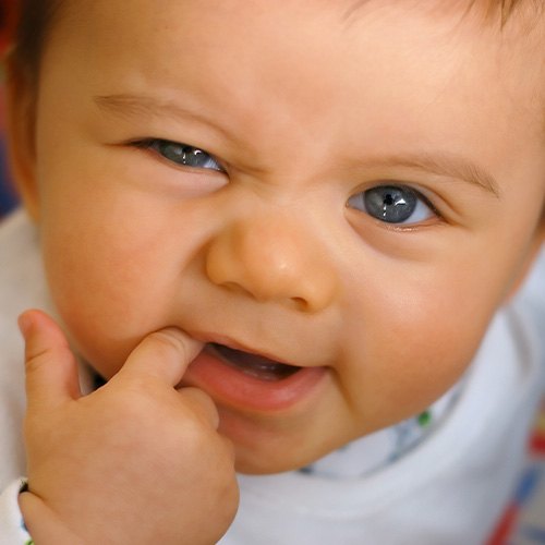 baby with finger in mouth